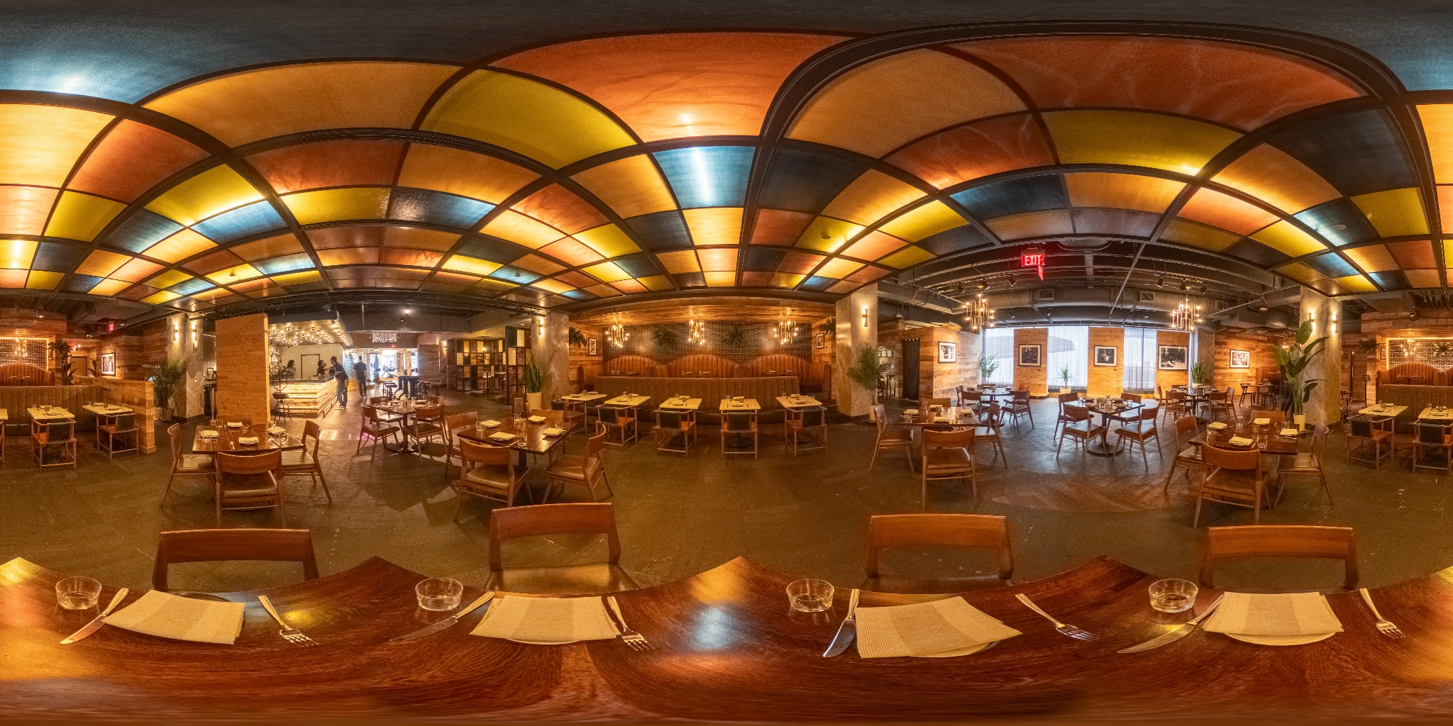360 degree panorama of a restaurant dining room with warm architectural lighting
